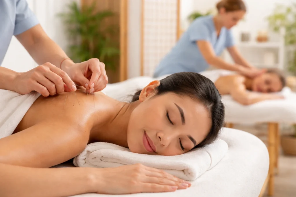 Woman experiencing cervical spine pain in neck seeking acupuncture treatment in Frederiksberg clinic